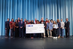 CREEED and SISD leadership recognize teachers from Col. John O. Ensor Middle School with a large check as part of the 3rd Annual AIM High initiative.