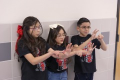 Students at Carroll T. Welch Elementary demonstrate a breathing exercise.