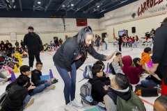 A teacher at Carroll T. Welch Elementary high fives a student during the Friday morning meeting.