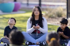 A teacher at Carroll T. Welch Elementary leads her students in breathing exercises.
